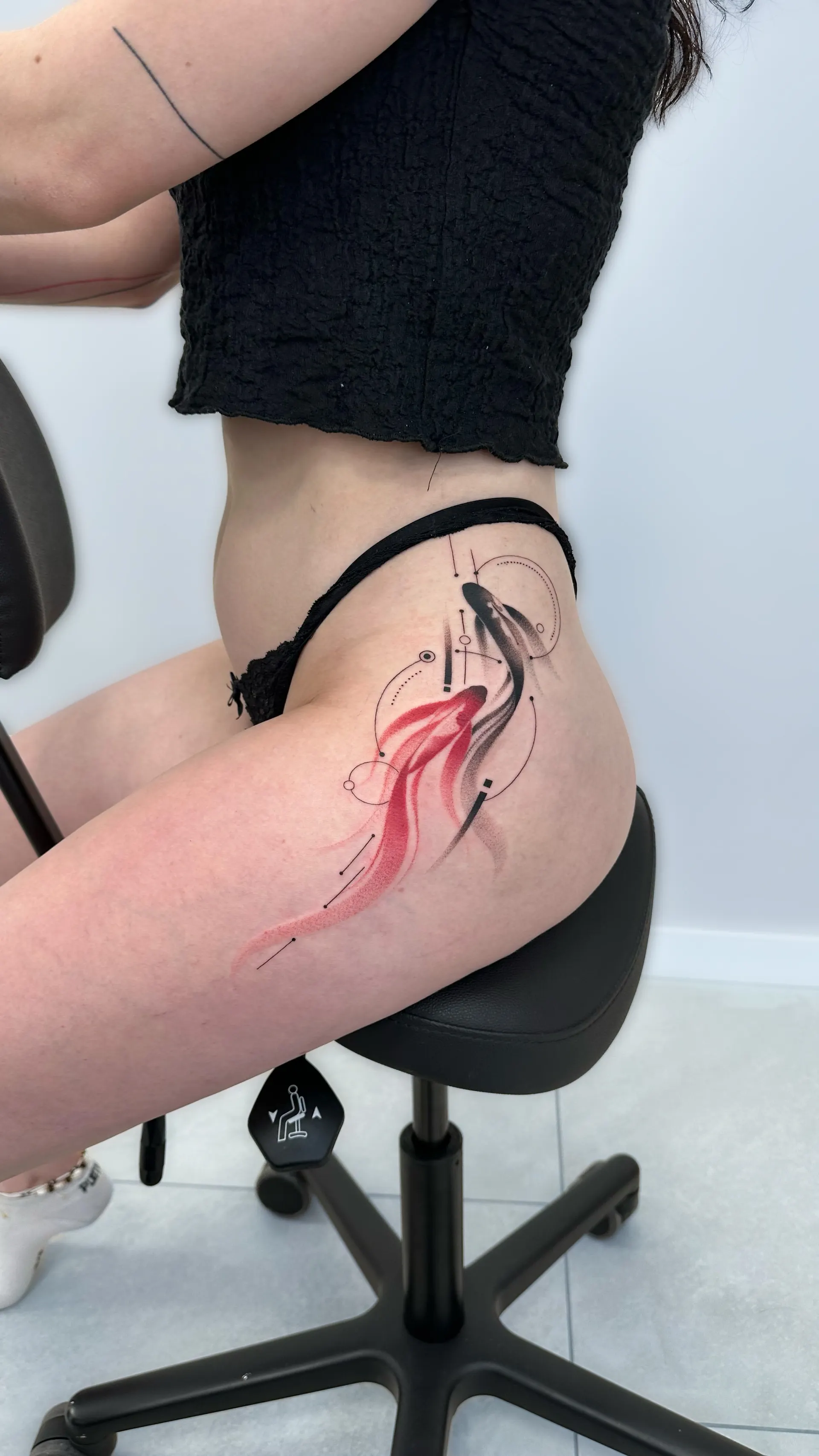 Rotes Tuschemotiv an Huefte und Oberschenkel – Colour Tattoo