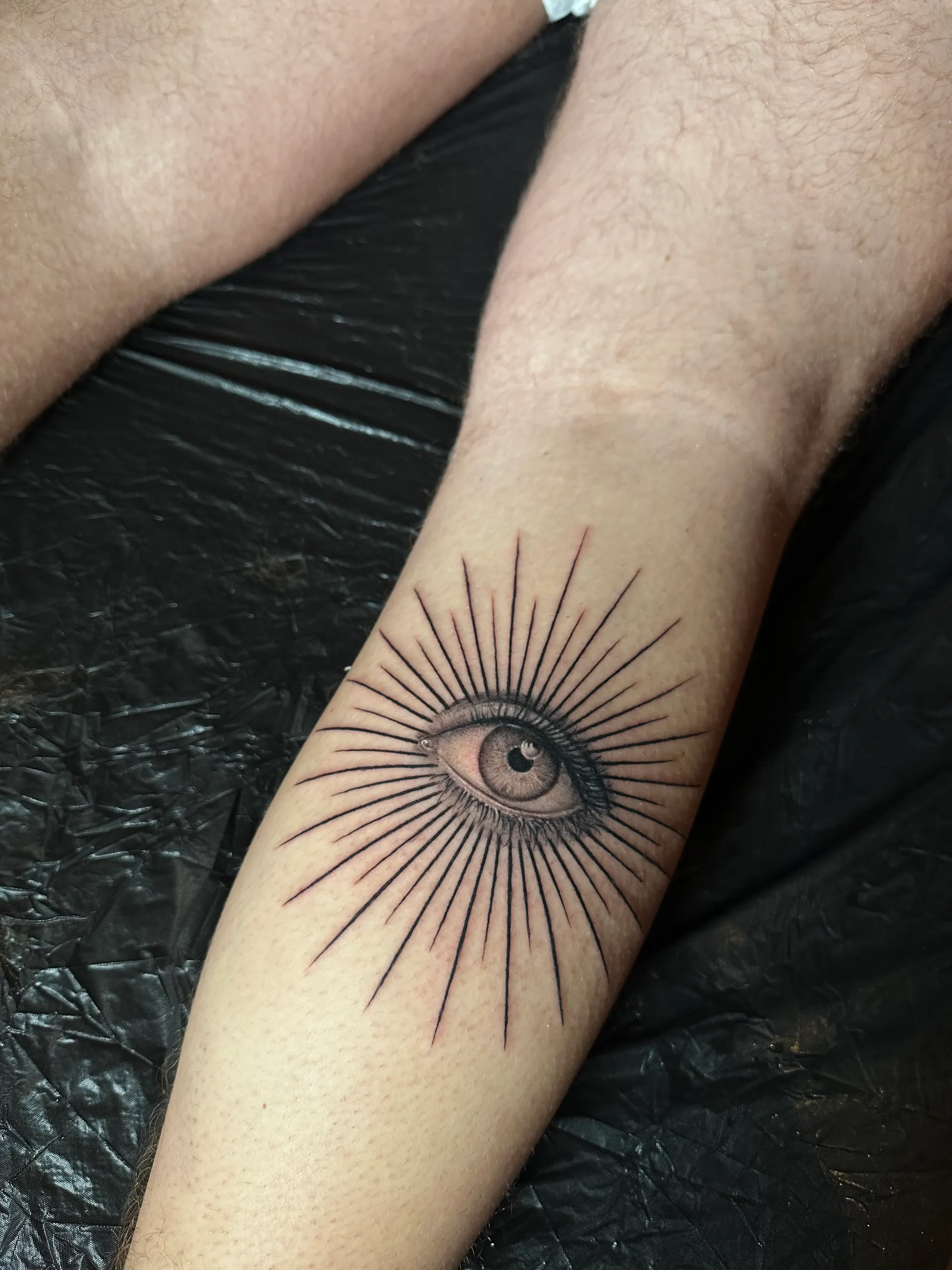 Auge mit Strahlen am Unterarm – Micro Realism Tattoo